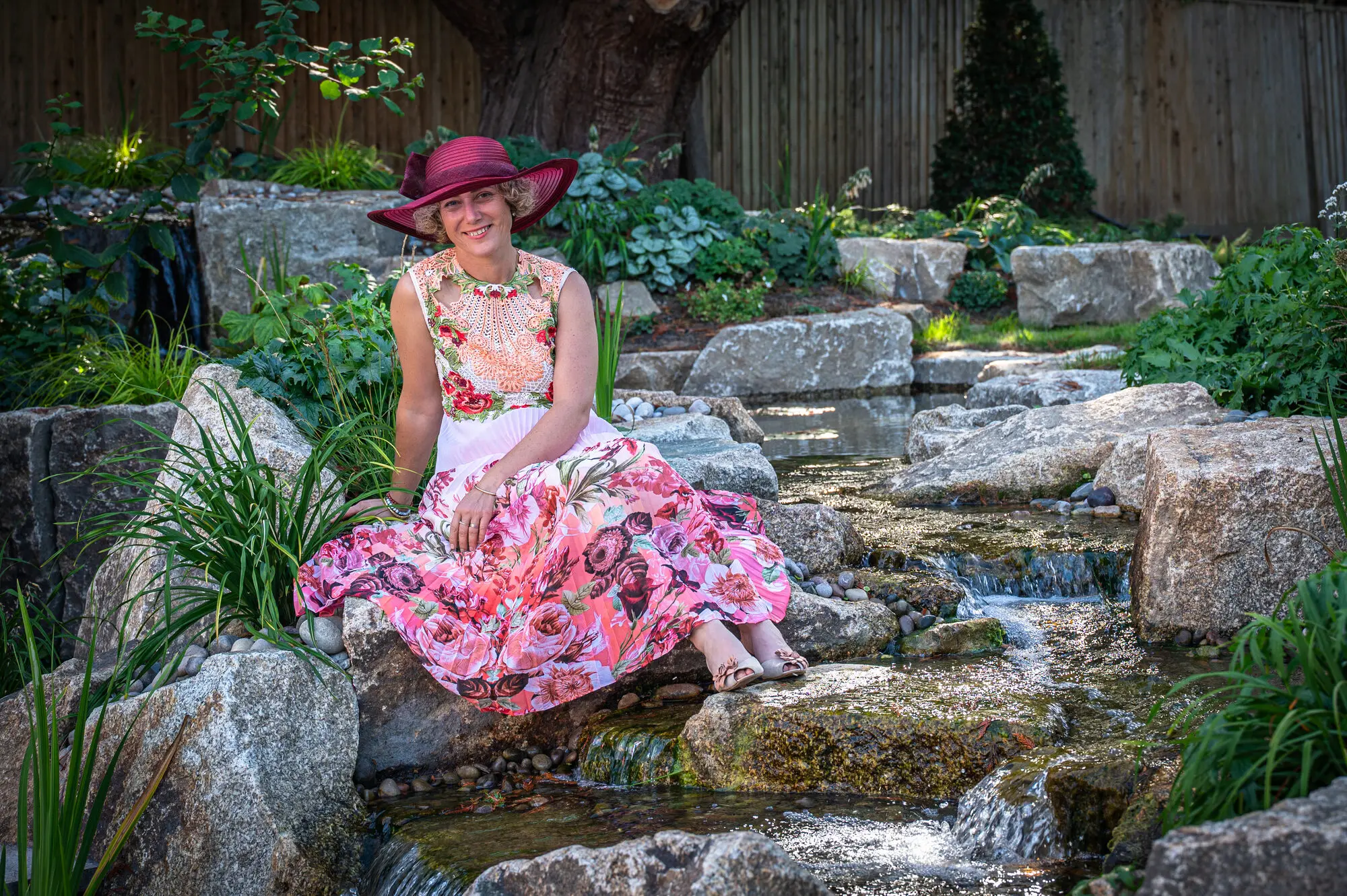 Kitti Kovacs sitting on the granite rocks by the stream that runs between the ponds