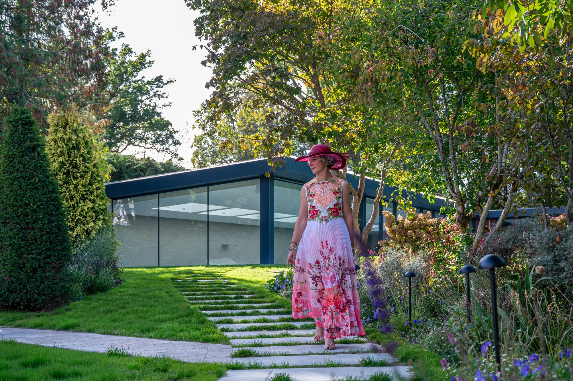Kitti Kovacs walking along the stepping stones towards the pool house