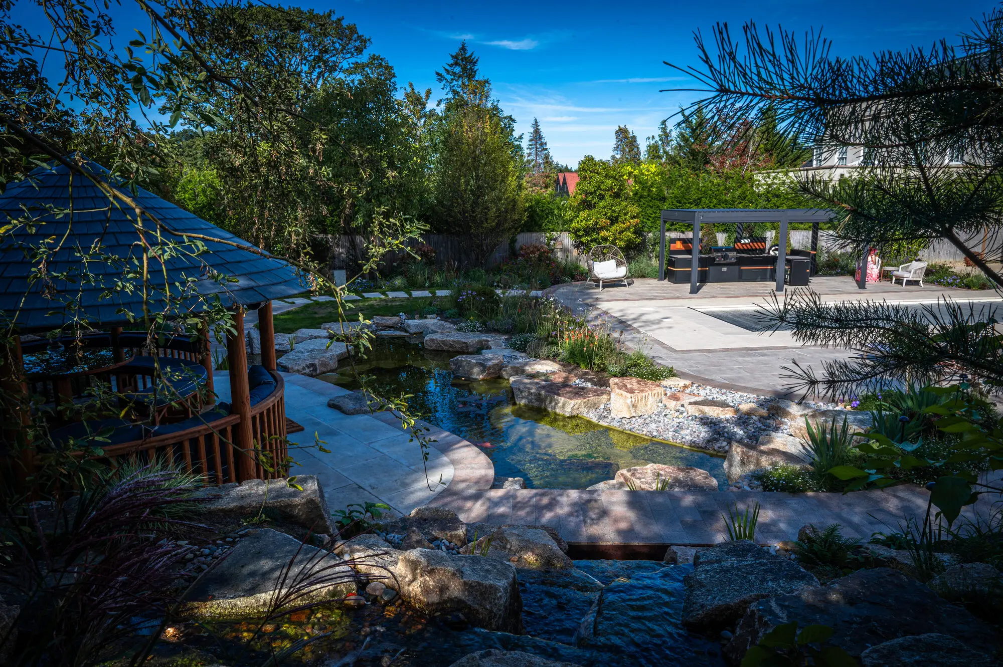 The stream running past the Breeze House towards the pool terrace and the pergola
